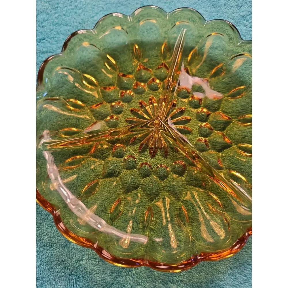 Vintage amber glass divided relish dish with pressed floral pattern.